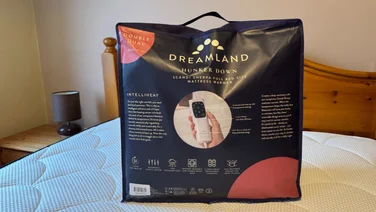 Dreamland Hunker Down Scandi Sherpa Electric Blanket in packaging on a bed