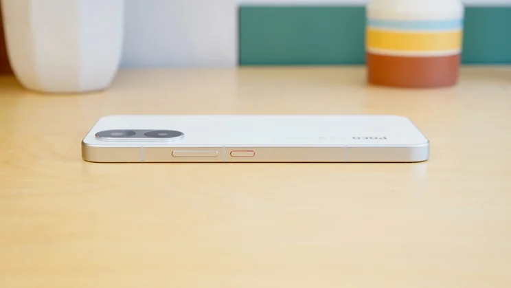 Poco X8 Pro Max face down on a table, side view