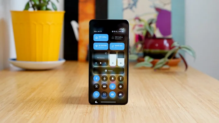 Xiaomi Poco X7 Pro standing upright on a table, display showing the control centre