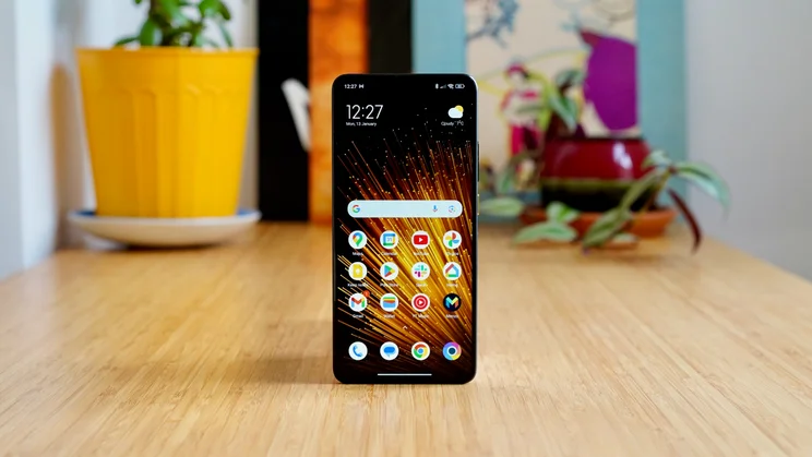 Xiaomi Poco X7 Pro standing upright on a table, display showing the homescreen