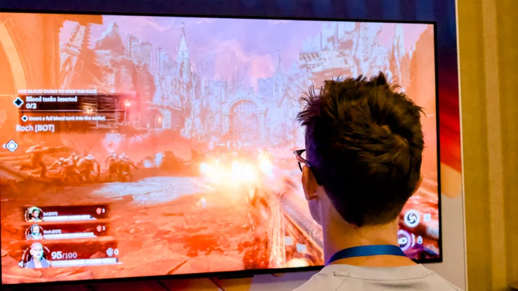 An image showing a man playing the Painkiller game on a Panther Lake reference platform
