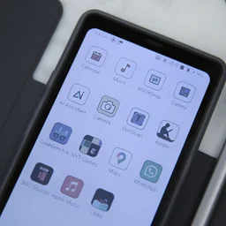 The Boox Palma 2 Pro digital note taker in its case with the Boox InkSense Plus stylus on a marble table top