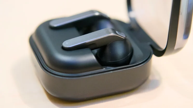 A close up image of the Samsung Galaxy Buds 4 Pro in their charging case, lid open, from the side