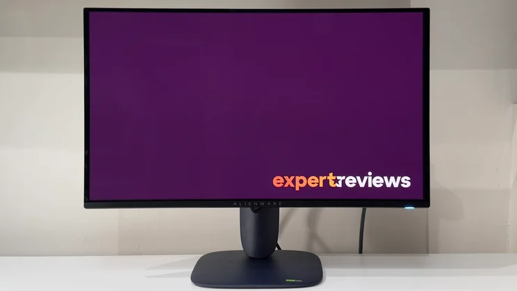 The Alienware AW2725D pictured from the front on a white desk against a white background