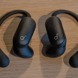 The Anker Soundcore AeroFit 2 Pro on a wooden table