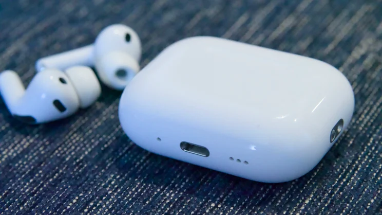The Apple AirPods Pro 3 charging base with earbuds in the background