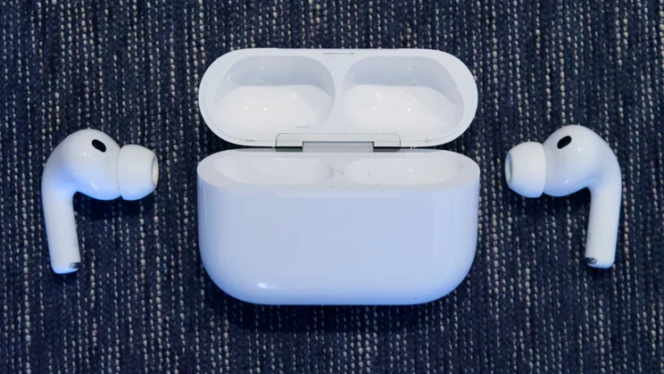 The Apple AirPods Pro 3 earbuds flanking their charging case
