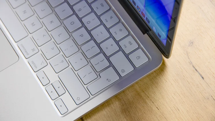 Apple MacBook Neo in silver, open, close up on the top right corener of the keyboard