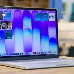 Apple MacBook Neo in silver, open, pictured from the front left quarter