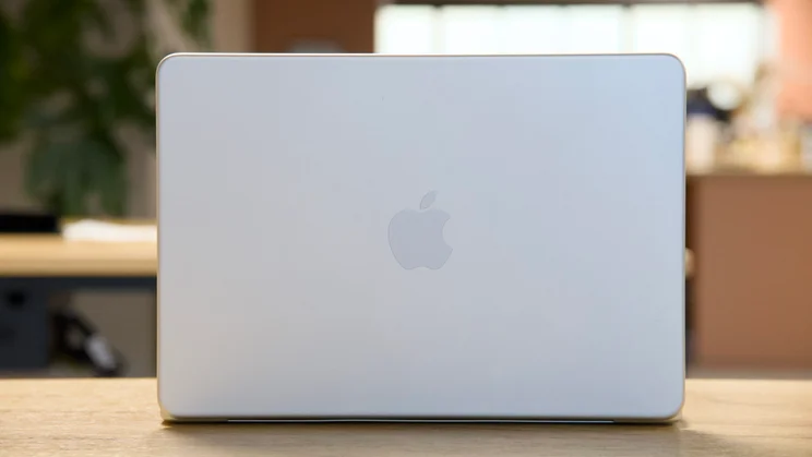 Apple MacBook Neo, open, in silver, pictured from the rear