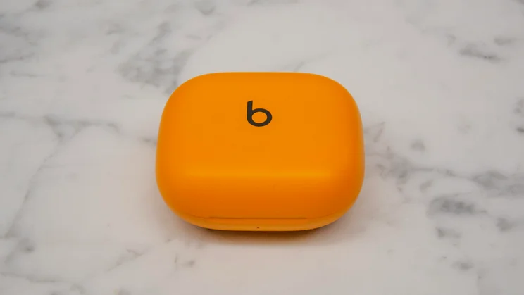 Beats Powerbeats Pro 2 in their case, closed, on a white countertop