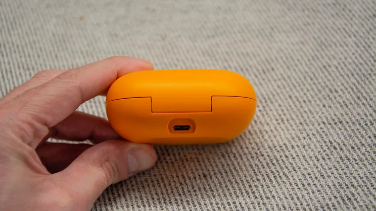 Beats Powerbeats Pro 2 case, in hand, showing the charging port