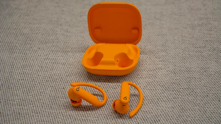 Beats Powerbeats Pro 2 in front of their open charging case