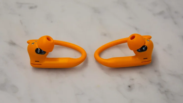Beats Powerbeats Pro 2 earbuds side by side on a white countertop