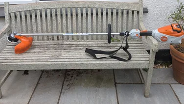 Stihl FSA 80R cordless strimmer on a garden bench