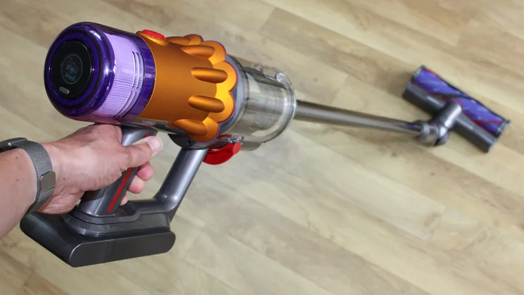 Man using a Dyson cordless vacuum cleaner