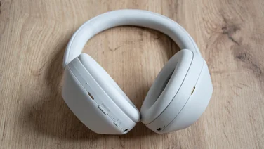 Sony WH-1000XM5 laid down showing noise cancelling button