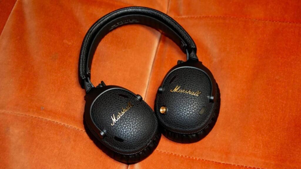 Marshall Monitor III ANC over-ear headphones on an orange sofa
