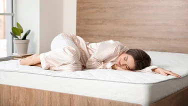 Best orthopaedic mattress header young lady lying peacefully on the mattress