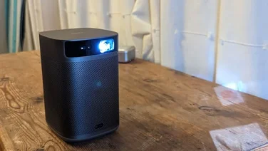 Best portable projector - featured image with the XGIMI MoGo 2 Pro positioned on a wooden table
