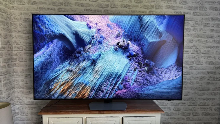 The Samsung QN90F Mini LED TV on a wooden table