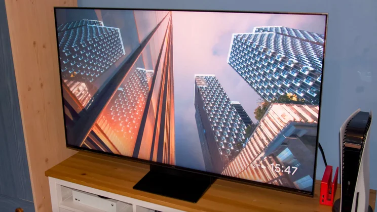 A skyscraper screensaver being displayed on the TCL C7K Mini LED TV