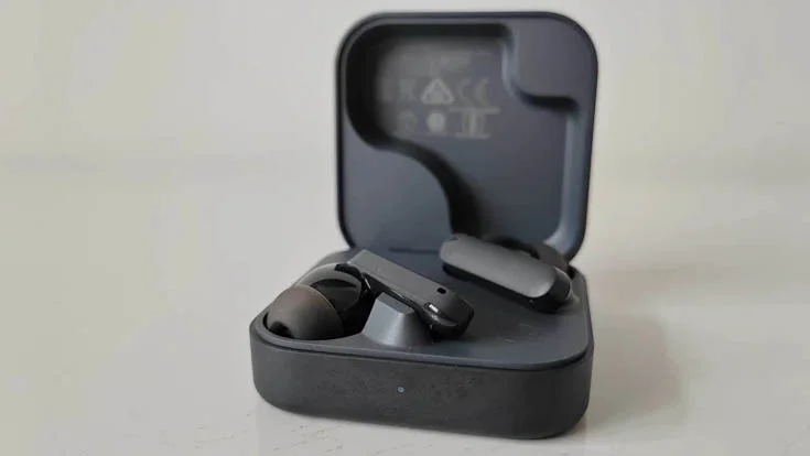 The CMF Buds 2 wireless earbuds on a grey table
