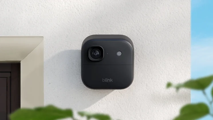 The Blink Outdoor Camera 2K+ mounted on a white outdoor wall