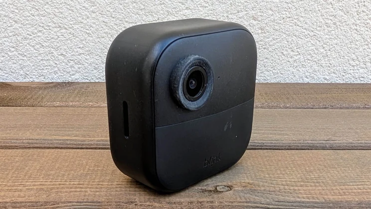 Angled view of the Blink Outdoor 4 camera on a wooden table