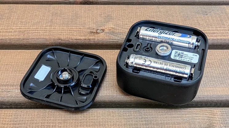 The Blink Outdoor 4 camera with its back plate removed and AA batteries exposed