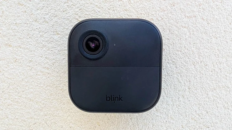 Front view of the Blink Outdoor 4 camera mounted on a white wall