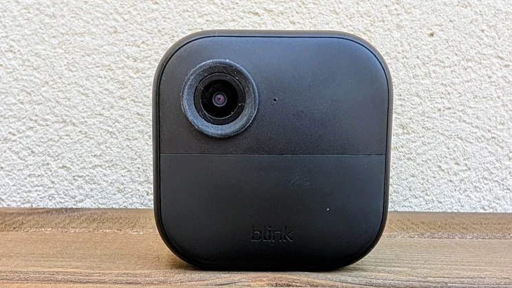 Front view of the Blink Outdoor 4 camera on a wooden table