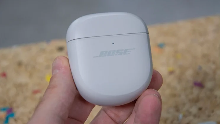 The Bose QuietComfort Ultra Earbuds 2nd Gen charging case being held in the hand of our reviewer