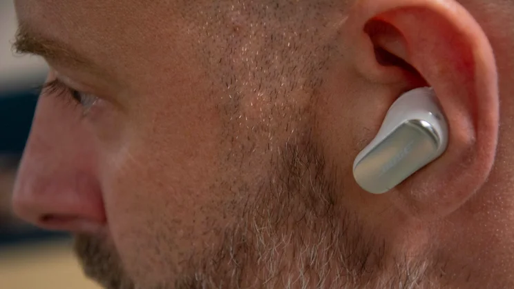 Close-up of the left earbud of the Bose QuietComfort Ultra Earbuds 2nd Gen being worn