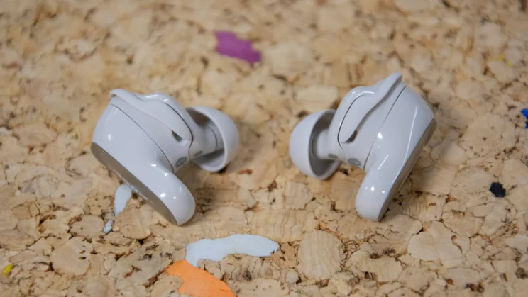 The Bose QuietComfort Ultra Earbuds 2nd Gen on a cork table with their eartips facing inwards