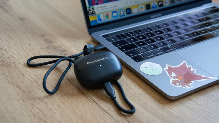 Image of the Bowers & Wilkins Pi8 connected to a MacBook Pro via USB-C cable