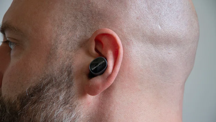 Close up of the left earbud of the Bowers & Wilkins Pi8 being worn in-ear