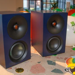 The Cambridge Audio L/R S active speakers side-by-side on a table with St Patrick's Day balloons