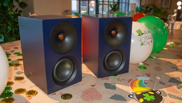 The Cambridge Audio L/R S active speakers side-by-side on a table with St Patrick's Day balloons