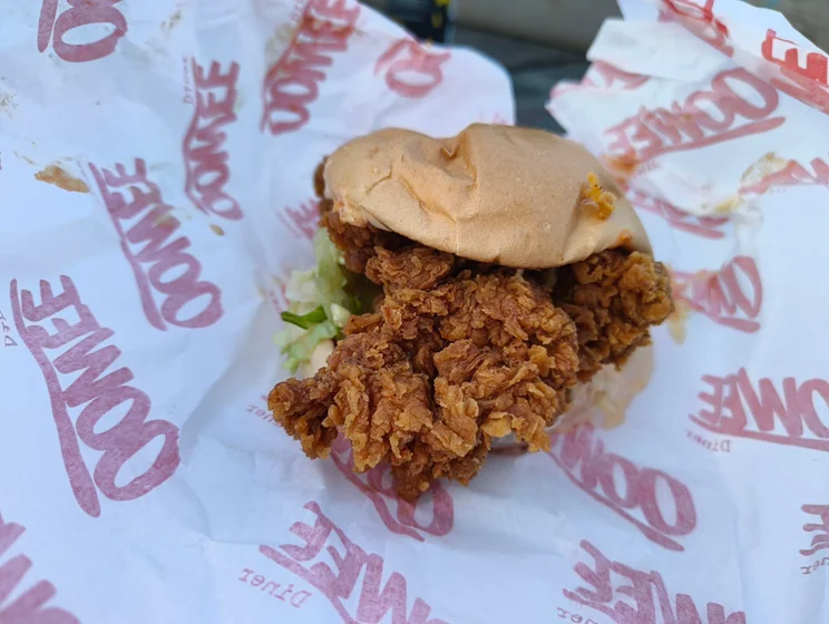 A chicken burger in paper wrapping