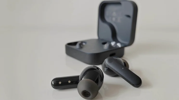 The CMF Buds 2 wireless earbuds outside of their charging case, which has its lid open