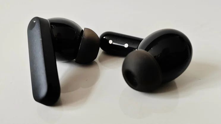 The CMF Buds 2 wireless earbuds side by side on a white table