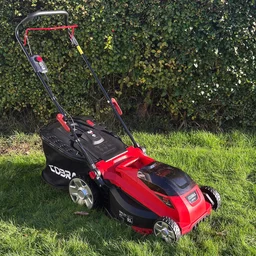 The Cobra MX4340VX lawn mower on a lawn in front of a hedge