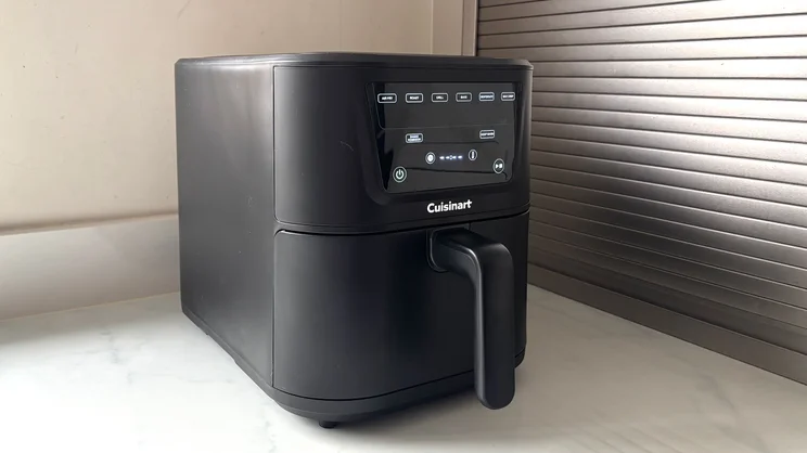 The Cuisinart Compact Max Air Fryer, with its display on, on a kitchen worktop