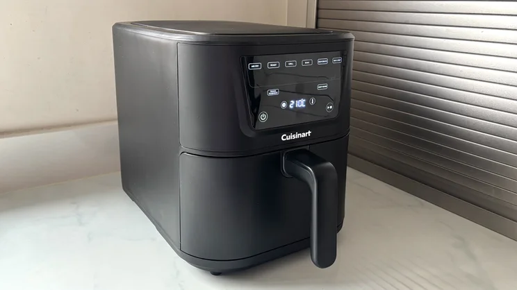 The Cuisinart Compact Max Air Fryer, with its display on, on a kitchen worktop