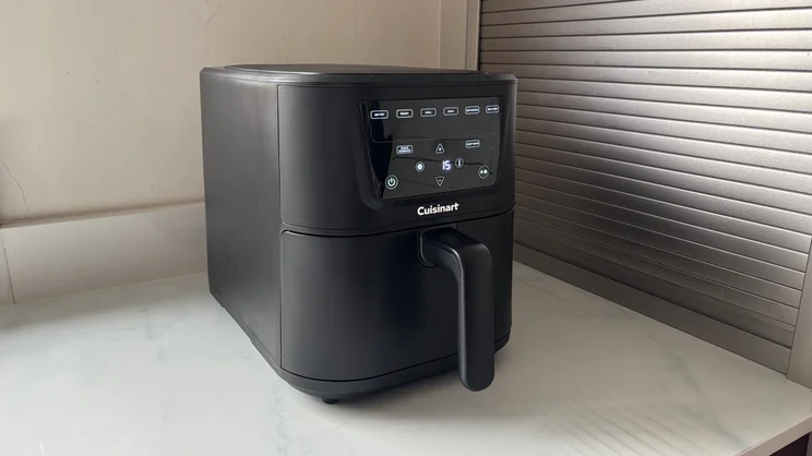 The Cuisinart Compact Max Air Fryer, with its display on, on a kitchen worktop