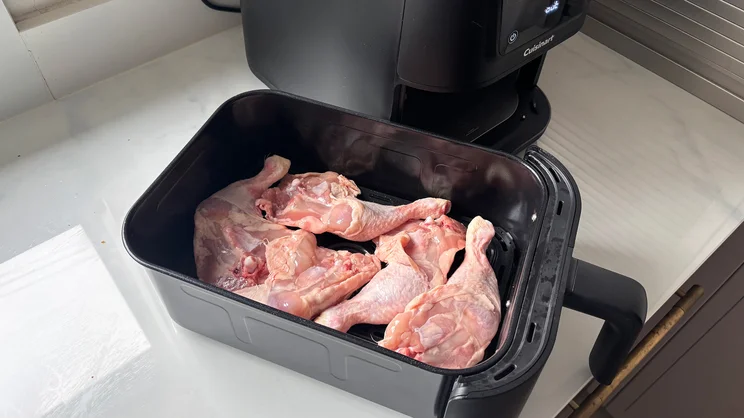 Raw chicken legs in the drawer of the Cuisinart Compact Max Air Fryer