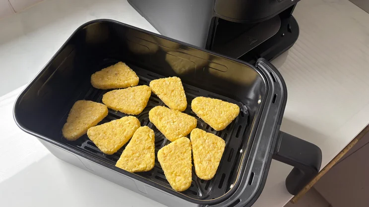 Raw hash browns in the drawer of the Cuisinart Compact Max Air Fryer