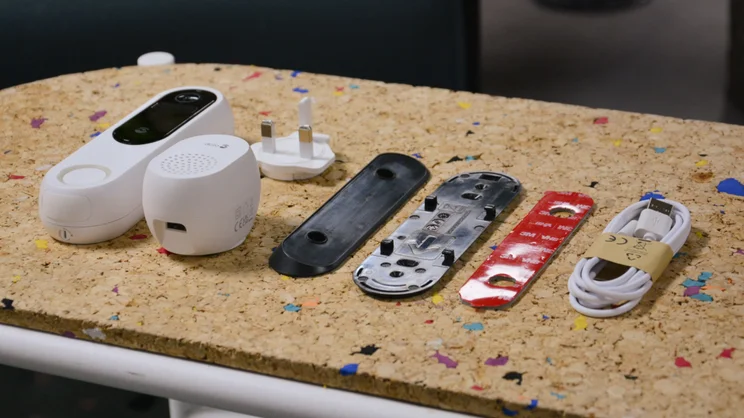 Doro Hemma Doorbell box contents, laid out on a cork surface, pictured at an angle