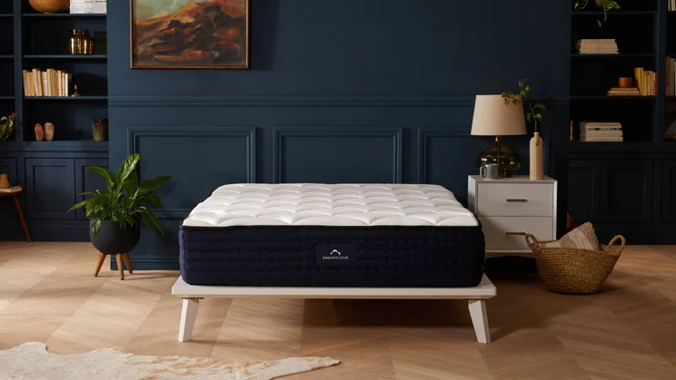 Dreamcloud Luxury Hybrid mattress side against dark wall